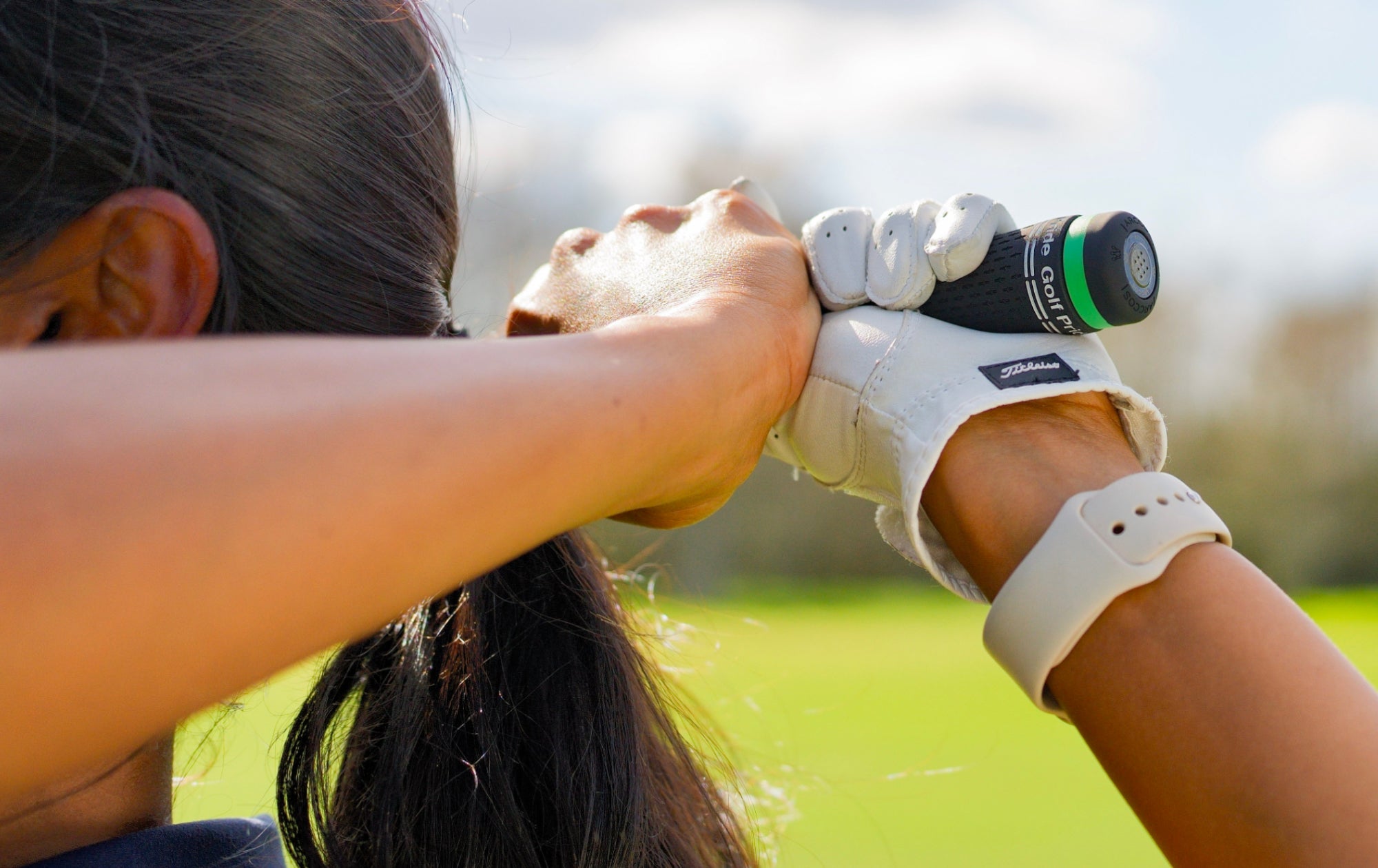 Woman using Arccos Sensor wearing Titleist Golf Glove 